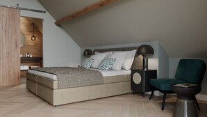 A modern bedroom with a large bed, a bedside table with a lamp, a chair, and a wooden wardrobe. - Luxury Villa With Sauna Near the Beach (De Cocksdorp)