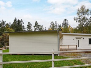 A two-story building with a flat roof, a white exterior, and a number '10' on the side. - 4 Star Holiday Home in Loftahammar (Loftahammar)