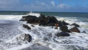 A rocky shoreline with waves crashing against the rocks. - 16 Person Holiday Home in Ulfborg (Ulfborg)