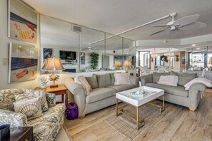A living room with a sofa, coffee table, and decorative lamps.