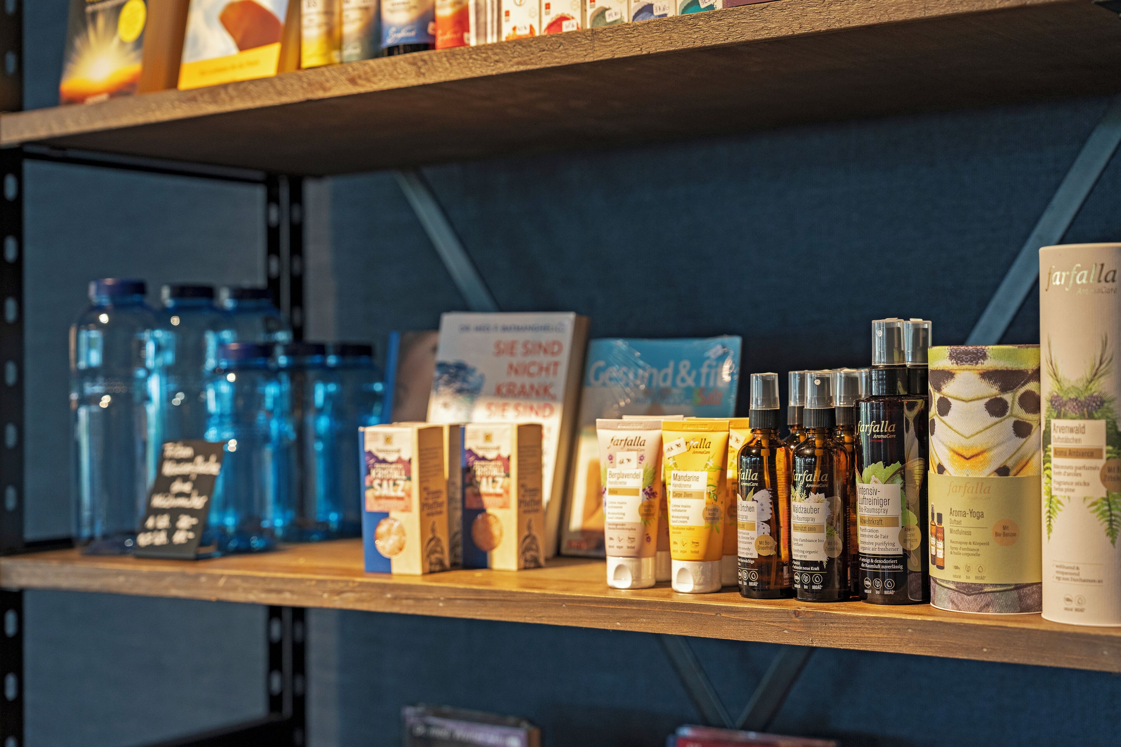 Una estantería con varios productos, incluyendo frascos, cajas y botellas, probablemente en una tienda.