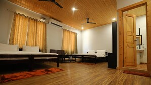 A room with two beds, a wooden ceiling, and a door leading to a bathroom. - Le ROI Floating Huts & Eco Rooms (Tehri)
