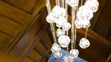 A chandelier with multiple crystal-like elements hanging from a metal structure.