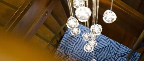 A chandelier with multiple crystal-like elements hanging from a metal structure.
