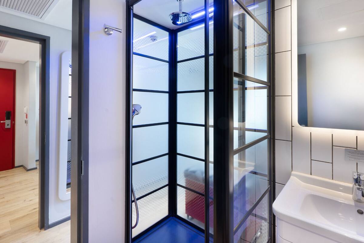 executive suite | bathroom | shower, rainfall showerhead, hair dryer, towels