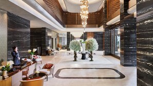A modern hotel lobby with a reception desk, seating area, and a large chandelier. - Mandarin Oriental Bosphorus, Istanbul (Istanbul)
