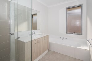 Bathtub, hair dryer, towels, soap -  INTO THE BLUE - Beachfront Busselton Holiday Home (Geographe)