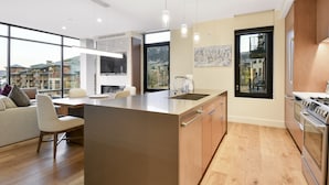 A modern kitchen with a large island, built-in appliances, and large windows offering views of the surrounding area. - Mountain 1BR in Canyons Village-Ski in/ski out by RedAwning (Park City)