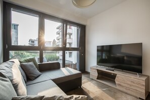 Deluxe Apartment | Living room | 55-inch flat-screen TV with satellite channels, TV, heated floors