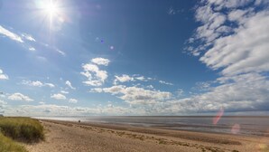 A beach with a clear sky and sunlight. - Heacham Hidey Hole, Heacham, Norfolk (Heacham)