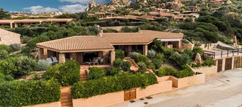 Family villa with garden, large veranda and sea-view pool at sunset