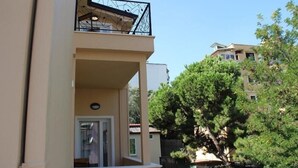 A two-story building with a balcony, a window, and a door. - Hermes Hotel (Tirana)