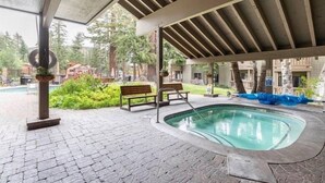 A covered outdoor area with a swimming pool, benches, and a pergola. - Season's Four 193-Mountain retreat close to town, shops, restaurants & more! (Mammoth Lakes)