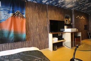 Relax in a stylish room with a large bed, flat-screen TV, and glass coffee table.