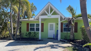 A house with a green exterior, white trim, and a number '305 A' on the front. - 2 Bedroom / 2 Bath Ground Level With a Heated Pool (Holmes Beach)