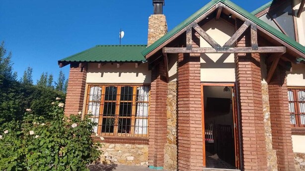 A two-story building with a green roof, a stone chimney, and a wooden door. - House for rent for this summer 2021 in San Rafael Mendoza (San Rafael)