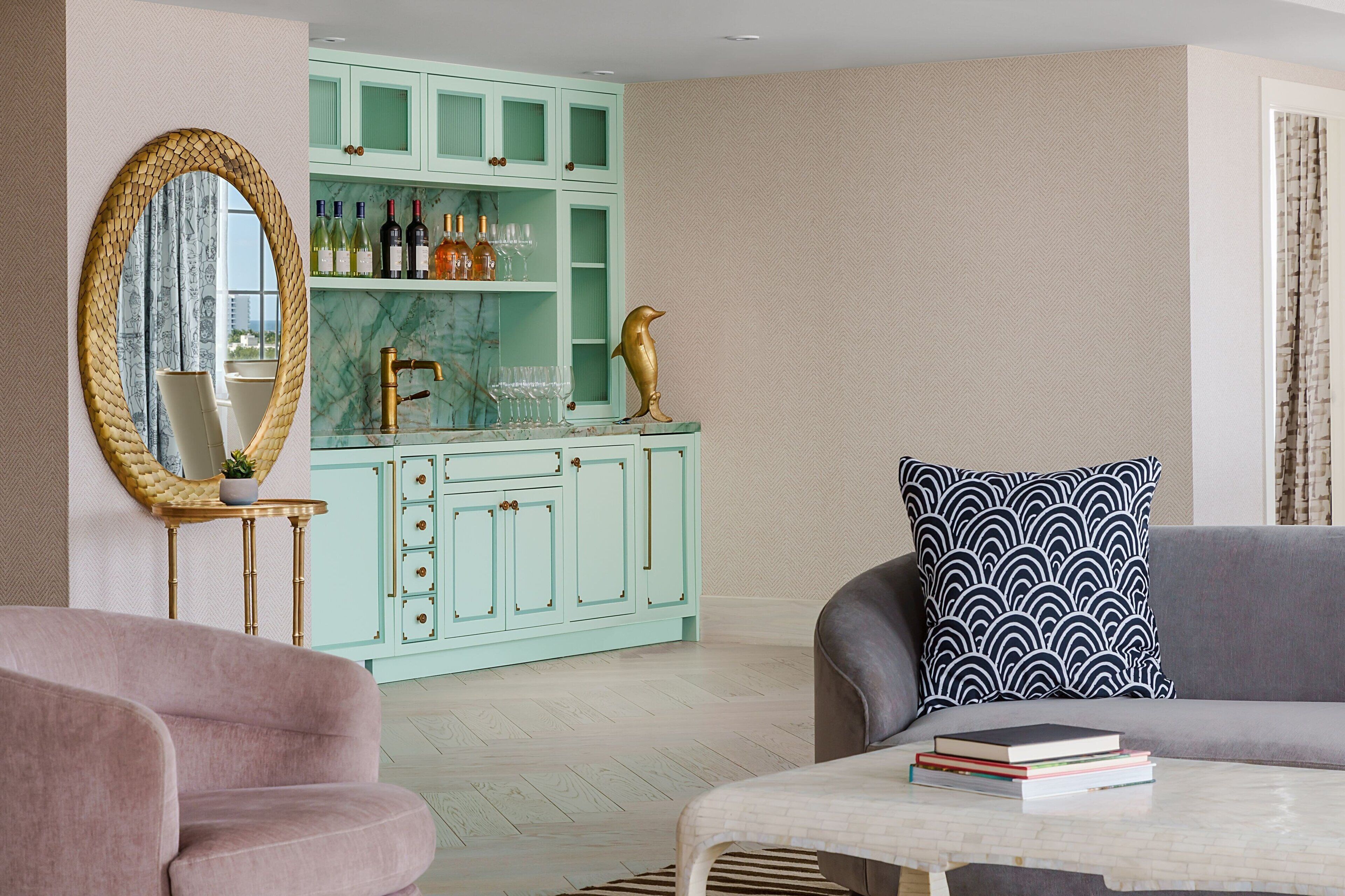 A living room with a teal cabinet, a mirror, a sofa, and a coffee table.