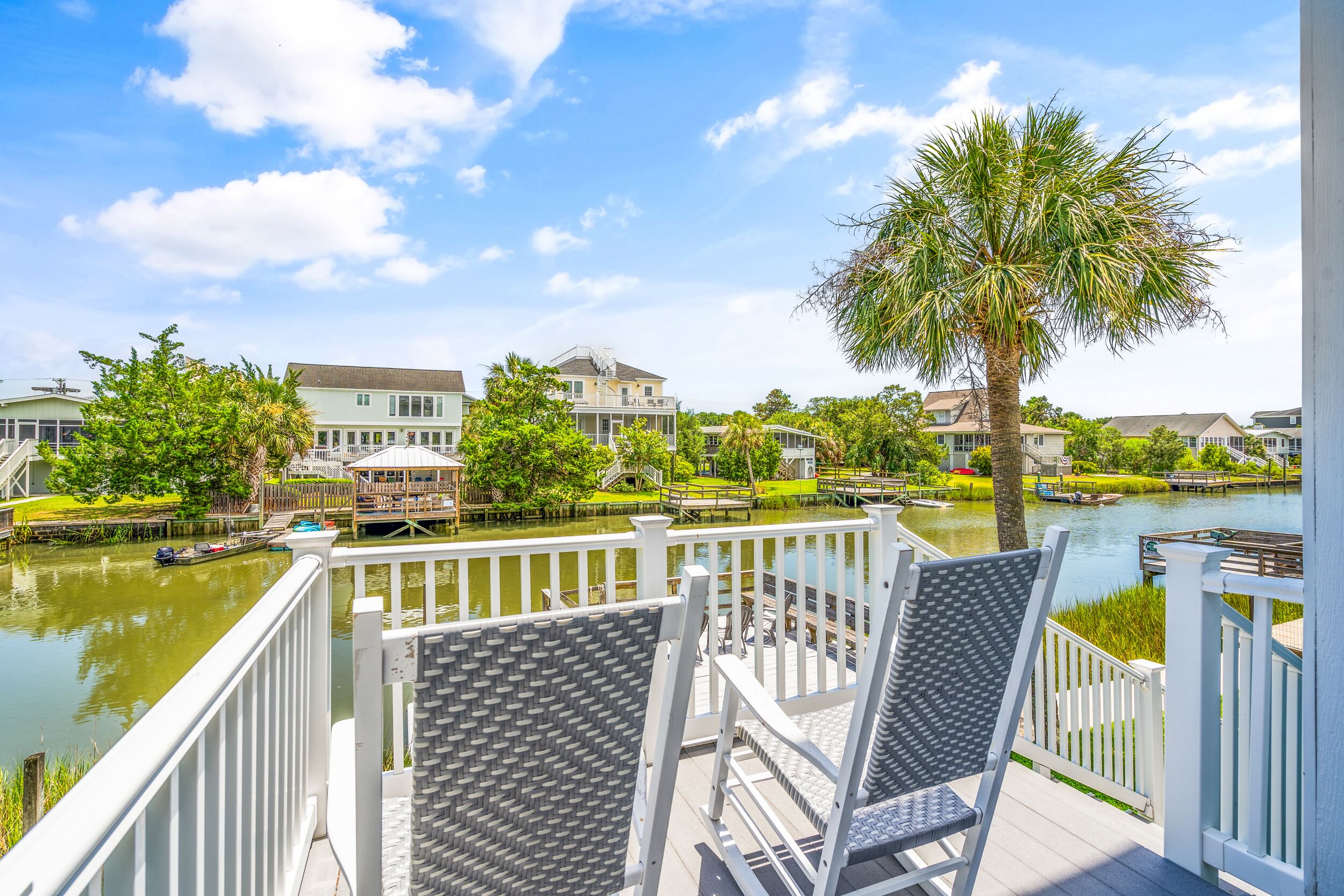 Enjoy peaceful canal views from these rocking chairs on a back deck