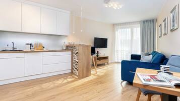 A modern apartment with a kitchen, dining area, and living room.