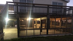 A two-story building with a balcony and a covered patio area. - Getaway By The Bay Unit 1 (Sargent)