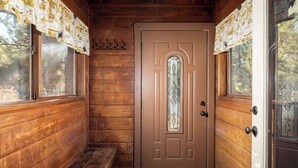 A wooden cabin interior with a door, windows, and a bench. - Snow Summit Dome Home. Walk to Snow Summit. HotTub (Big Bear Lake)