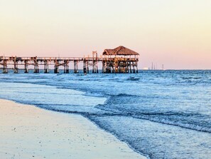 A pier extending into the sea with a thatched-roof structure at the end. - BEACHSIDE CONDO, OCEANFRONT COMPLEX, STEPS TO THE BEACH, HEATED POOL! (Cocoa Beach)
