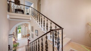 A grand staircase with ornate metal railings leading to an upper level. - Historical Villa Vigneri with pool and large garden (Novigrad)