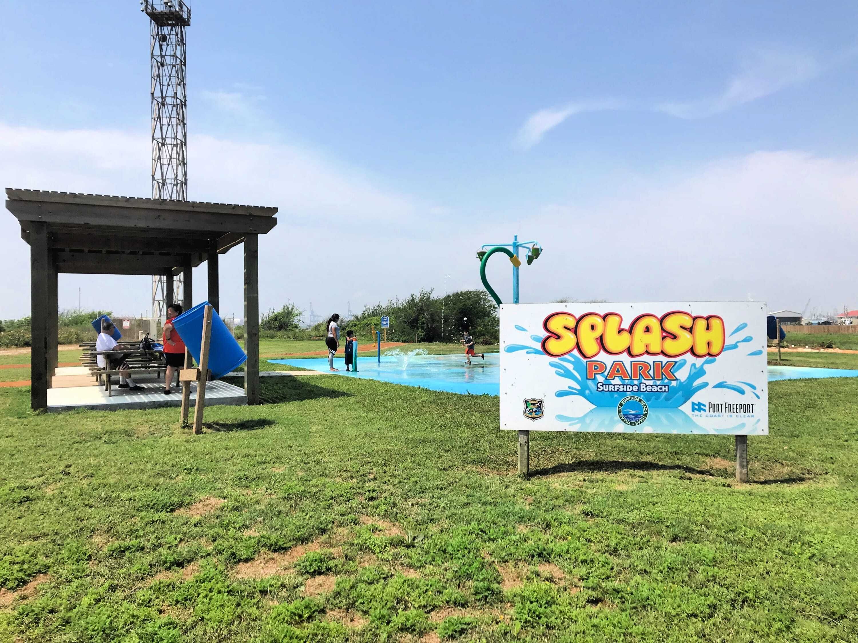 A Splash Park with a water play area, picnic tables, and a covered seating area.