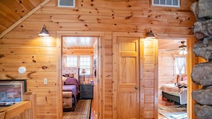 A wooden cabin interior with a bedroom, a bathroom, and a living area. - On Beautiful White River, Minutes from Sylamore Creek and Blanchard Springs (Mountain View)