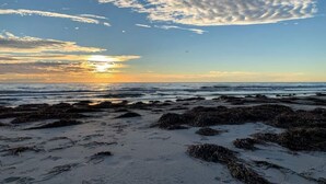 A beach with rocky terrain and waves.