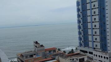 A high-rise building with a view of the sea.