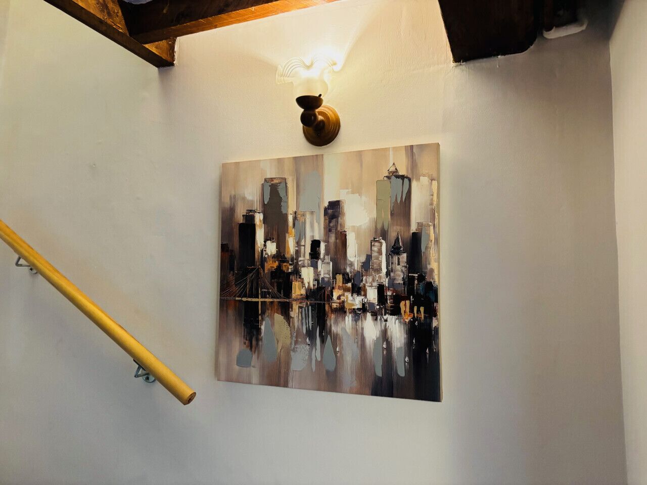 A painting of a cityscape on a wall.