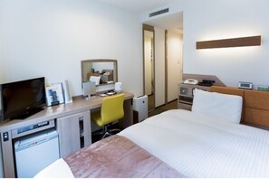Relax in a comfortable room with a bed, desk, and flat-screen TV.