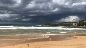 A beach with waves and a cloudy sky. - World famous beach location Manly (Sydney)