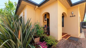 A building with a beige exterior, a sign reading "Bullalo," and a brick pathway leading to the entrance. - Cullalo ArtHouse- gorgeous accommodation combined with an art gallery! - Stunning one bedroom apartment in east Albury (East Albury)