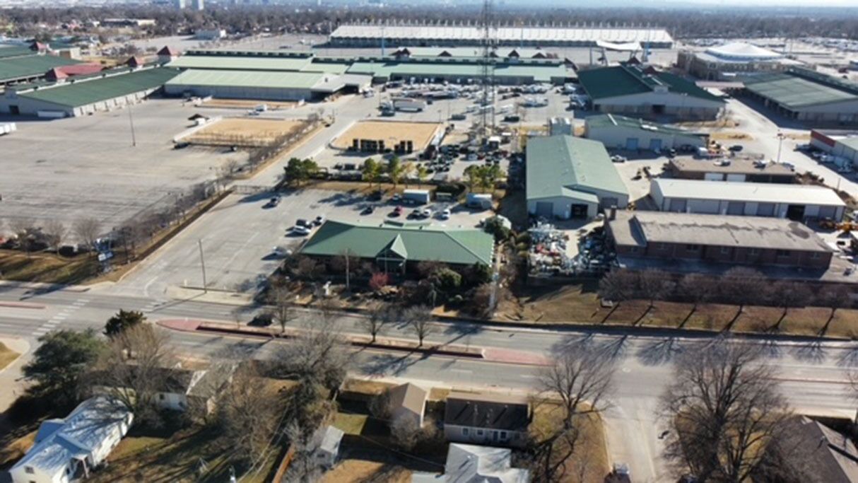 An industrial area with large buildings, parking lots, and a few smaller structures.