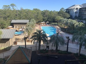 Relax by the resort's central pool surrounded by lush gardens and lounge areas.
