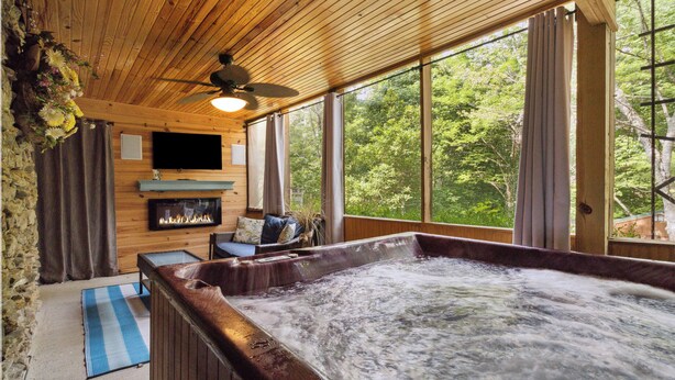 A wooden cabin with a hot tub, a fireplace, and large windows overlooking a forest. - Welcome to Charming Get-A-Way – Your Ultimate Escape!

 (Burnside)