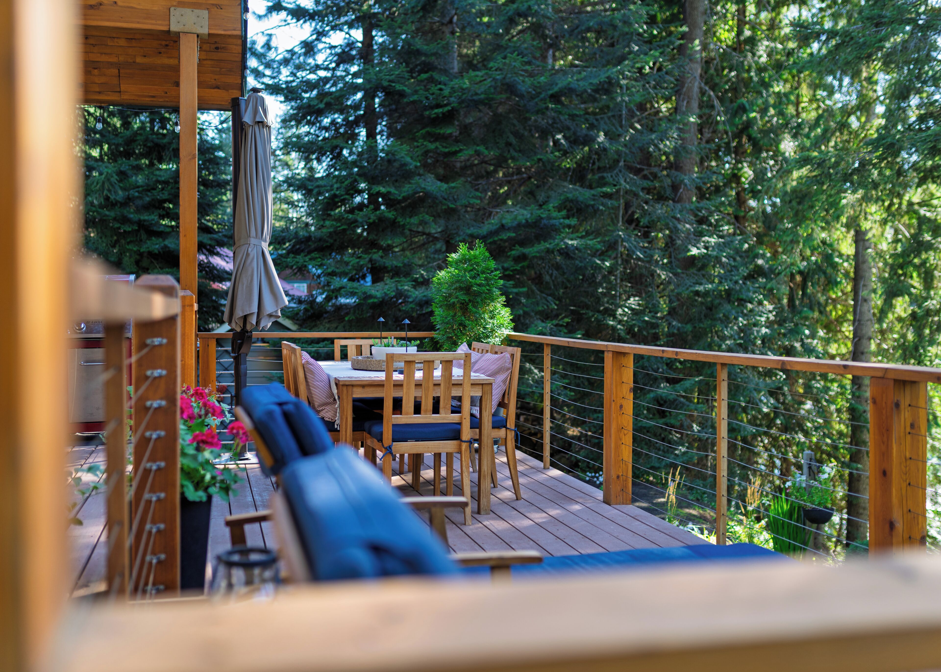 Dine & relax on a forested deck overlooking the river.