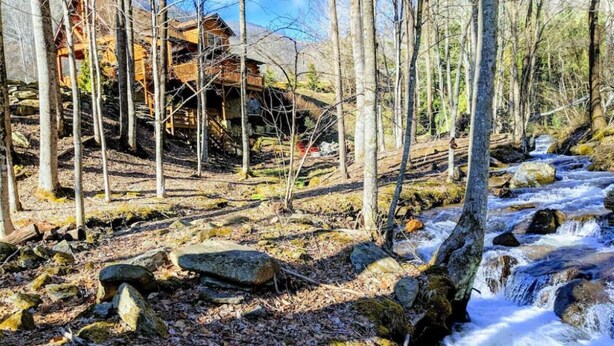 A rustic wooden cabin surrounded by a forest with a flowing stream. - "Rushing Bear!"   Fully furnished two bedroom cozy cabin you want to capture!" (Maggie Valley)