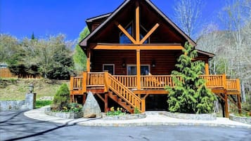 Stroll through the beautifully landscaped grounds to the central entrance, flanked by two staircases leading to a covered porch.