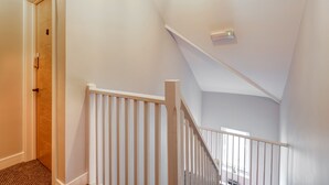 A staircase with white railings and a wooden door at the top. - Bondgate Hotel East Midlands Airport (Derby)