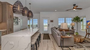 A modern kitchen with a marble island, pendant lights, and a ceiling fan. - b6 sun and sand, B6 Oceanfront Ocean Lakes (Myrtle Beach)