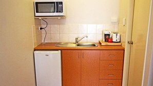 A compact kitchen with a microwave, sink, and a small refrigerator. - Suite 26 |Town Central | Walk To Cafes | Sleeps 3 (Margaret River)