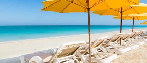 On the beach, sun-loungers, beach towels