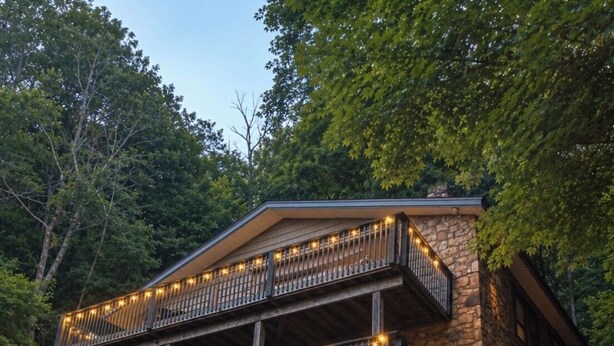 A two-story stone building with balconies, wooden railings, and a staircase. - Base Camp at Hawks nest. Near many mountain activities! (Seven Devils)