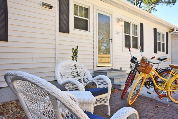 Relax on the inviting porch with two comfortable chairs and a bicycle at the ready.