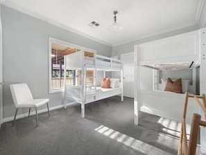 A child's room with bunk beds, a white chair, and a window with blinds. - Burton Farmhouse Reconnect with Nature and Family (Wilyabrup)