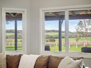 A room with two large windows offering a view of a vineyard. - Burton Farmhouse Reconnect with Nature and Family (Wilyabrup)
