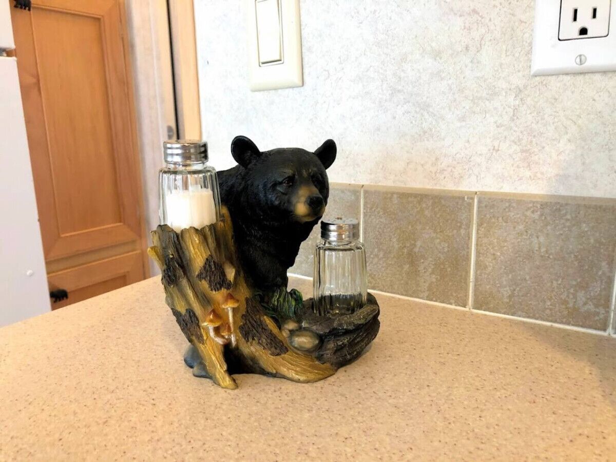 A kitchen counter with a bear-shaped salt and pepper shaker set.